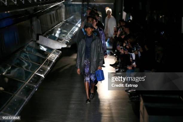 Model walks the runway at the Cottweiler show during London Fashion Week Men's January 2018 at Natural History Museum on January 6, 2018 in London,...