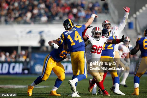 Earl Mitchell of the San Francisco 49ers pressures Sean Mannion of the Los Angeles Rams during the game at Los Angeles Memorial Coliseum on December...