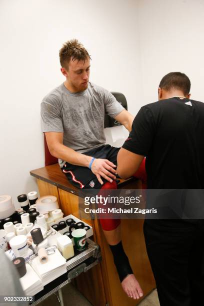 George Kittle of the San Francisco 49ers gets tapped up in the locker room prior to the game against the Los Angeles Rams at Los Angeles Memorial...