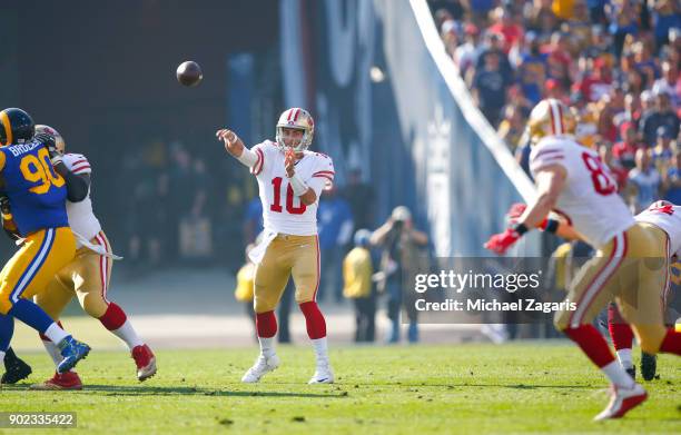 Jimmy Garoppolo of the San Francisco 49ers passes to George Kittle during the game against the Los Angeles Rams at Los Angeles Memorial Coliseum on...