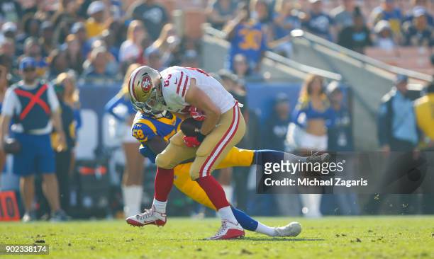 George Kittle of the San Francisco 49ers gets tackeld after making a reception during the game against the Los Angeles Rams at Los Angeles Memorial...
