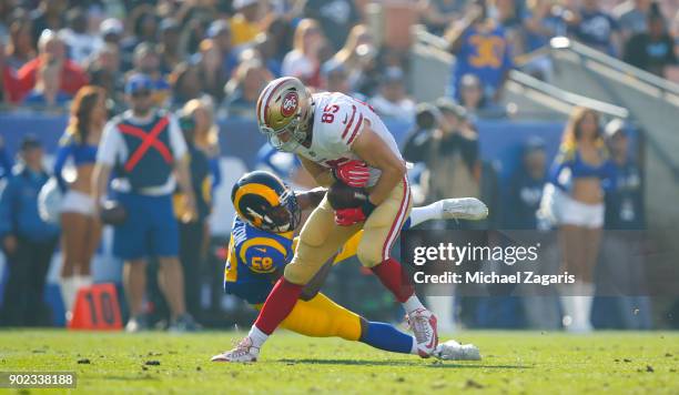 George Kittle of the San Francisco 49ers gets tackeld after making a reception during the game against the Los Angeles Rams at Los Angeles Memorial...