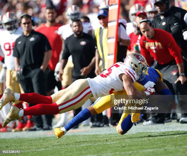 Gerald Everett of the Los Angeles Rams gest tackled by Eric Reid of the San Francisco 49ers after making a reception during the game at Los Angeles...