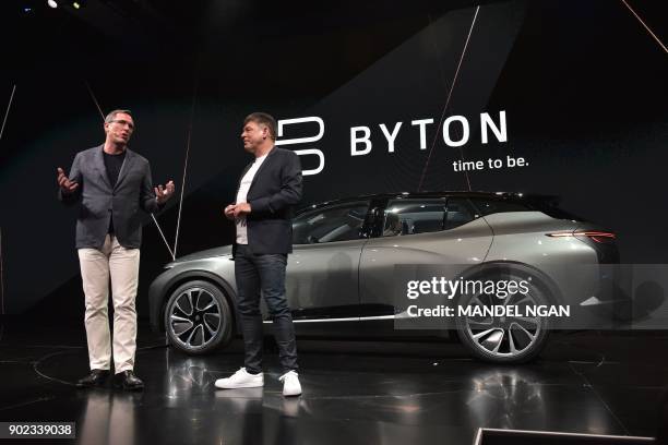 Byton President Daniel Kirchert and CEO Carsten Breitfeld speak during the launch of the Byton connected car during CES 2018 in Las Vegas on January...