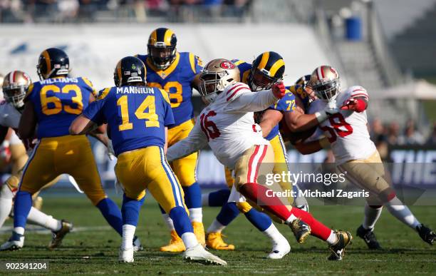 Sheldon Day of the San Francisco 49ers sacks Sean Mannion of the Los Angeles Rams during the game at Los Angeles Memorial Coliseum on December 31,...