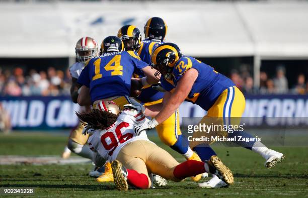 Sheldon Day of the San Francisco 49ers sacks Sean Mannion of the Los Angeles Rams during the game at Los Angeles Memorial Coliseum on December 31,...