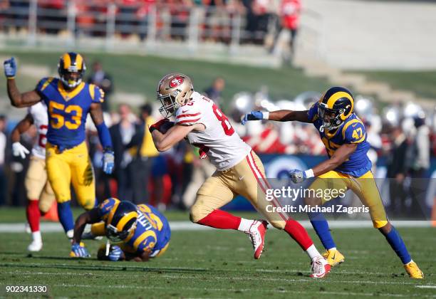 George Kittle of the San Francisco 49ers breaks free of a tackle after making a reception during the game against the Los Angeles Rams at Los Angeles...