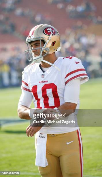 Jimmy Garoppolo of the San Francisco 49ers stands on the field prior to the game against the Los Angeles Rams at Los Angeles Memorial Coliseum on...