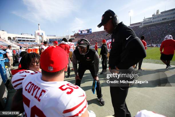 Defensive Backs Coach Jeff Hafley of the San Francisco 49ers talks with Reuben Foster and Brock Coyle on the sideline during the game against the Los...