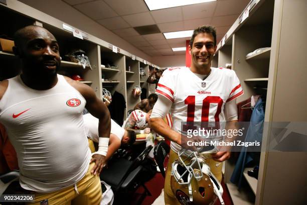 Elvis Dumervil and Jimmy Garoppolo of the San Francisco 49ers stand in the locker room following the game against the Los Angeles Rams at Los Angeles...