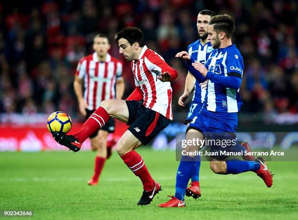 Alvaro Medran of Deportivo Alaves competes for the ball with Benat Etxebarria of Athletic Club during the La Liga match between Athletic Club Bilbao...