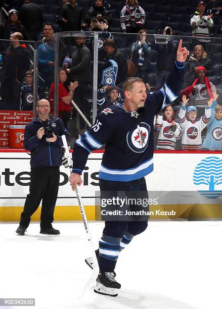 Matt Hendricks of the Winnipeg Jets salutes the fans after receiving first star honors following a 4-1 victory over the San Jose Sharks at the Bell...