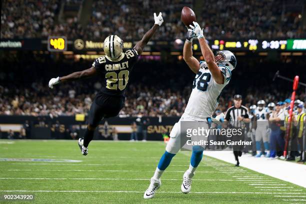 Greg Olsen of the Carolina Panthers has a pass broken up by Ken Crawley of the New Orleans Saints during the first half of the NFC Wild Card playoff...