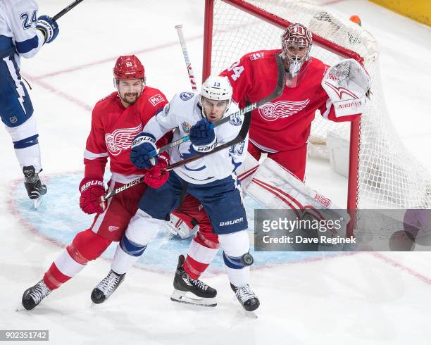 Goaltender Petr Mrazek of the Detroit Red Wings is screened as Cedric Paquette of the Tampa Bay Lightning battles in front of the net with Xavier...