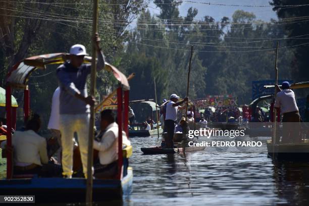 General view of a canal and its traditional "trajineras" -flat-bottomed river boats- at Xochimilco natural reserve in Mexico City on January 7, 2018....