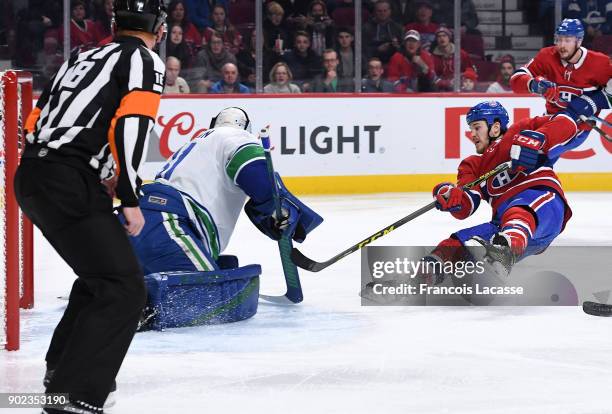 Andrew Shaw of the Montreal Canadiens takes a shot on goal Anders Nilsson of the Vancouver Canucks in the NHL game at the Bell Centre on January 7,...