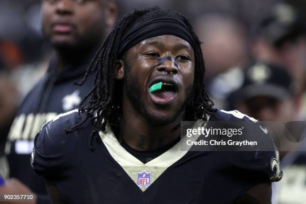 Alvin Kamara of the New Orleans Saints celebrates after a touchdown by eating Airheads candy on the sideline during the game against the Carolina...