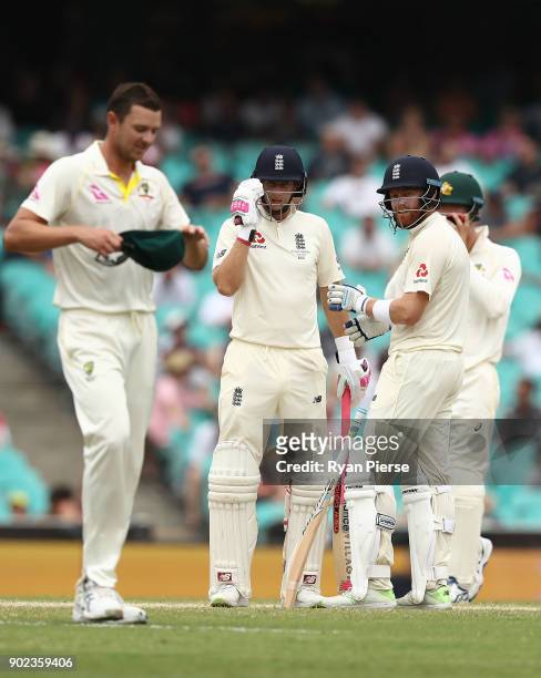 Joe Root of England and Josh Hazlewood of Australia exchange words during day five of the Fifth Test match in the 2017/18 Ashes Series between...