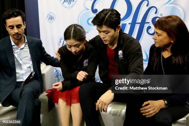 Maia Shibutani and Alex Shibutani react to their scores in the kiss and cry with their coaches Massimo Scali and Marina Zoueva after skating in the...