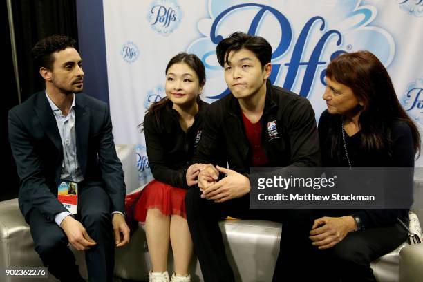 Maia Shibutani and Alex Shibutani react to their scores in the kiss and cry with their coaches Massimo Scali and Marina Zoueva after skating in the...