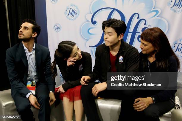 Maia Shibutani and Alex Shibutani react to their scores in the kiss and cry with their coaches Massimo Scali and Marina Zoueva after skating in the...