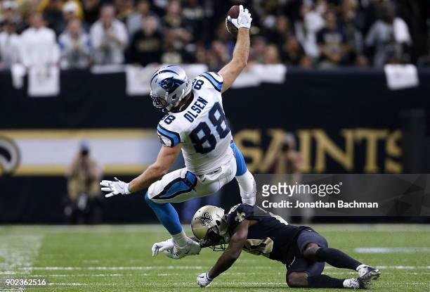 Ken Crawley of the New Orleans Saints tackles Greg Olsen of the Carolina Panthers during the second half of the NFC Wild Card playoff game at the...