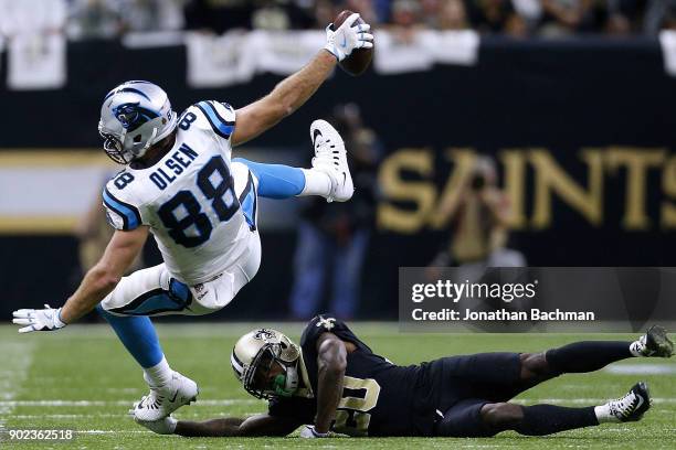 Ken Crawley of the New Orleans Saints tackles Greg Olsen of the Carolina Panthers during the second half of the NFC Wild Card playoff game at the...