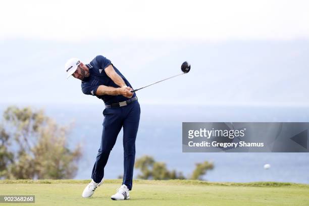 Dustin Johnson of the United States plays his shot from the 13th tee uring the final round of the Sentry Tournament of Champions at Plantation Course...