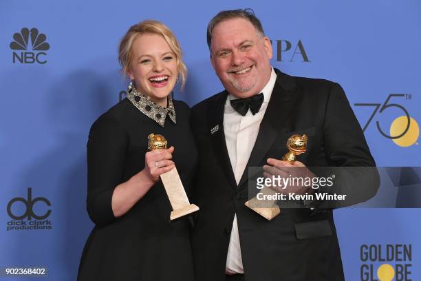 Producers Bruce Miller and Elisabeth Moss of 'The Handmaid's Tale' pose with their awards for Best Television Series Drama in the press room during...