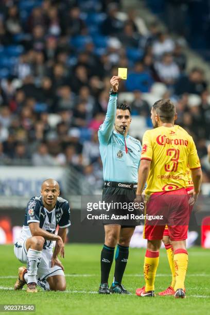 Referee Adonai Escobedo gives a yellow card to Gerardo Rodriguez of Morelia during the first round match between Monterrey and Morelia as part of the...