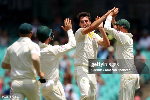 Pat Cummins of Australia celebrates after taking the wicket of Mason Crane of England during day five of the Fifth Test match in the 2017/18 Ashes...