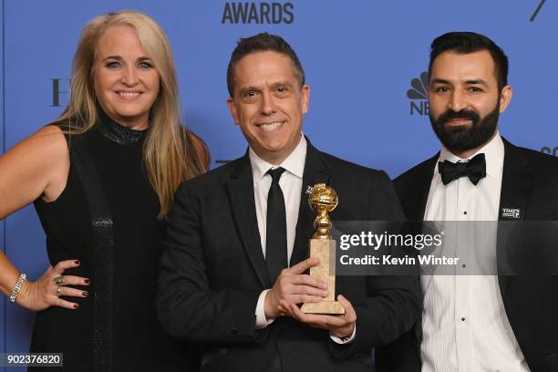 Producer Darla K. Anderson, director Lee Unkrich and Adrian Molina pose with the Best Motion Picture Animated for 'Coco' in the press room during The...