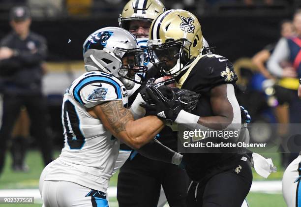 Carolina Panthers free safety Kurt Coleman tries to keep New Orleans Saints running back Alvin Kamara out of the end zone in the second half of their...