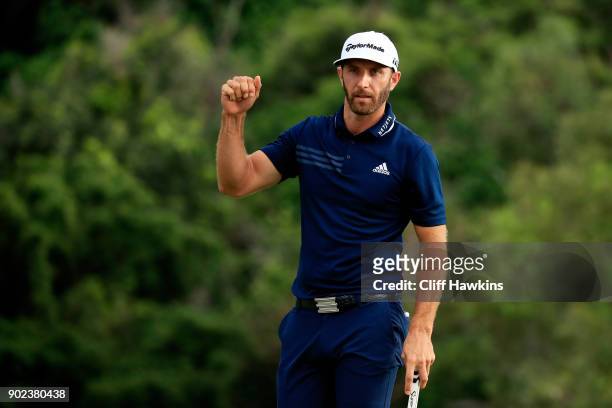 Dustin Johnson of the United States celebrates on the 18th green after winning during the final round of the Sentry Tournament of Champions at...