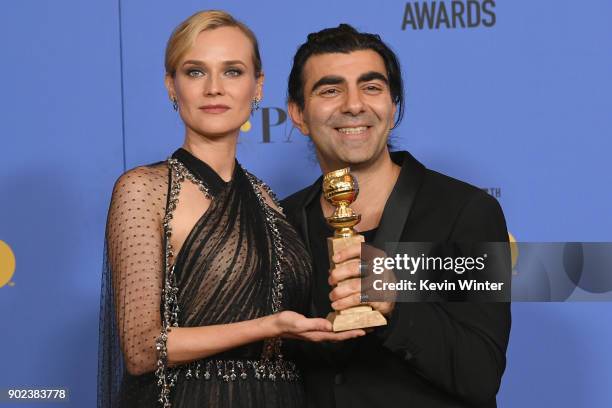 Actor Diane Kruger poses with director Fatih Akin and his award for Best Motion Picture Foreign Language for 'In The Fade' in the press room during...