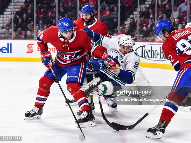 Joe Morrow of the Montreal Canadiens takes down Brendan Gaunce of the Vancouver Canucks during the NHL game at the Bell Centre on January 7, 2018 in...