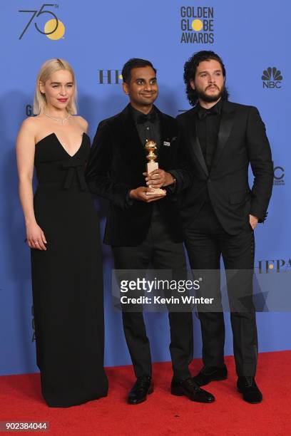 Actors Emilia Clarke and Kit Harington pose with Aziz Ansari and his award for Best Performance by an Actor in a Television Series Musical or Comedy...