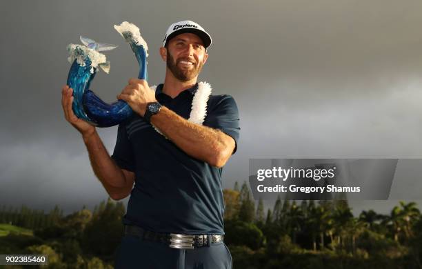 Dustin Johnson of the United States celebrates with the winner's trophy after winning during the final round of the Sentry Tournament of Champions at...