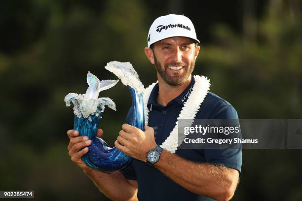 Dustin Johnson of the United States celebrates with the winner's trophy after winning during the final round of the Sentry Tournament of Champions at...