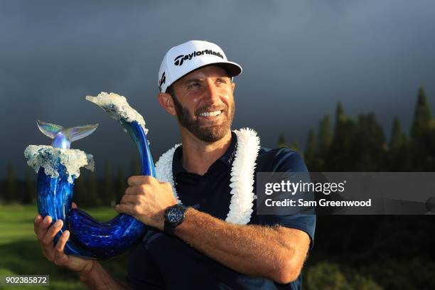 Dustin Johnson of the United States celebrates with the winner's trophy after the final round of the Sentry Tournament of Champions at Plantation...