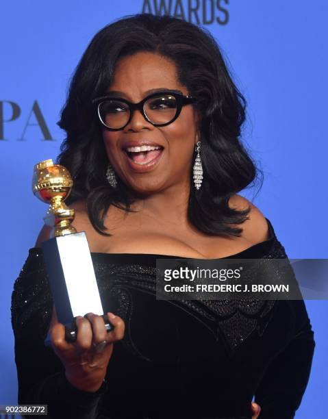 Actress and TV talk show host Oprah Winfrey poses with the Cecil B. DeMille Award during the 75th Golden Globe Awards on January 7 in Beverly Hills,...