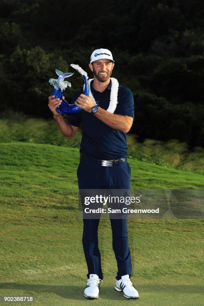 Dustin Johnson of the United States celebrates with the winner's trophy after the final round of the Sentry Tournament of Champions at Plantation...