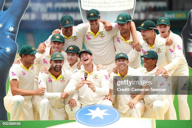 The Australian team celebrate winning the Ashes series with a replica Ashes Urn during day five of the Fifth Test match in the 2017/18 Ashes Series...