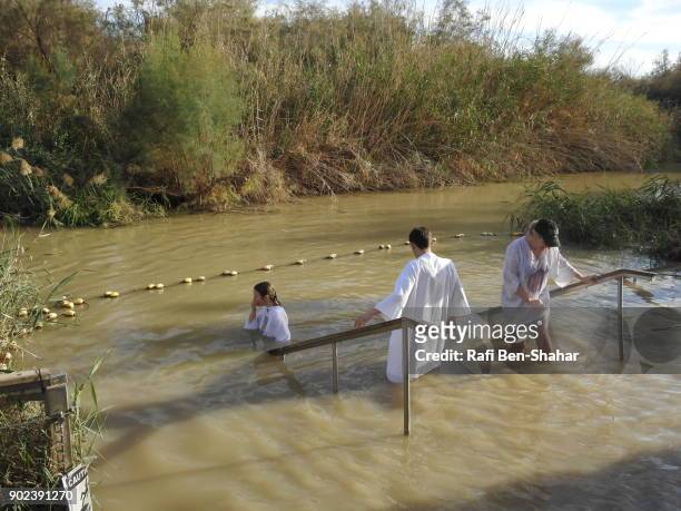 christian baptism in the jordan river israel side - christening gown stock-fotos und bilder
