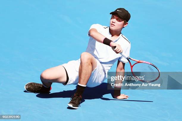 Yibing Wu of China falls as he returns a shot in his first round match against David Ferrer of Spain during day one of the ASB Men's Classic at ASB...