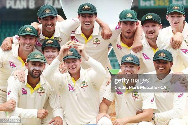 The Australian team celebrate winning the Ashes series with a replica urn during day five of the Fifth Test match in the 2017/18 Ashes Series between...