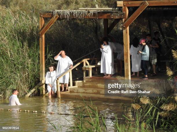 christian baptism in the jordan river jordan side - dopdräkt bildbanksfoton och bilder