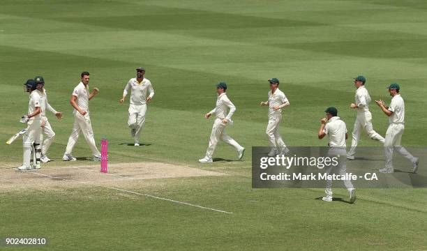 Josh Hazlewood of Australia celebrates with team mates after taking the wicket of James Anderson of England to win the fifth test and series on day...