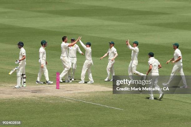 Josh Hazlewood of Australia celebrates with team mates after taking the wicket of James Anderson of England to win the fifth test and series on day...