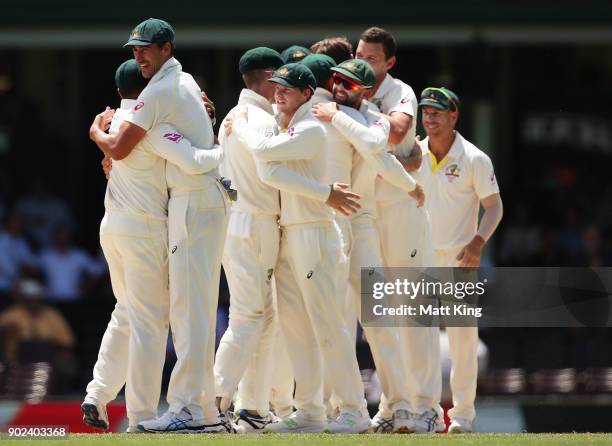 Australian players celebrate victory after the final wicket during day five of the Fifth Test match in the 2017/18 Ashes Series between Australia and...